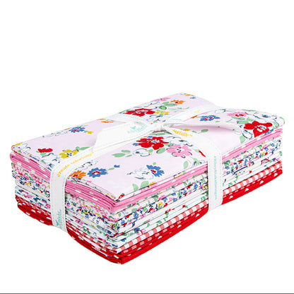 A stack of folded fabric bundles tied with a white ribbon, featuring floral and gingham patterns in pink, red, white, and blue on a plain white background.