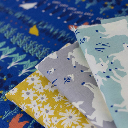 Collection of fabric swatches with various patterns including animals and flowers.