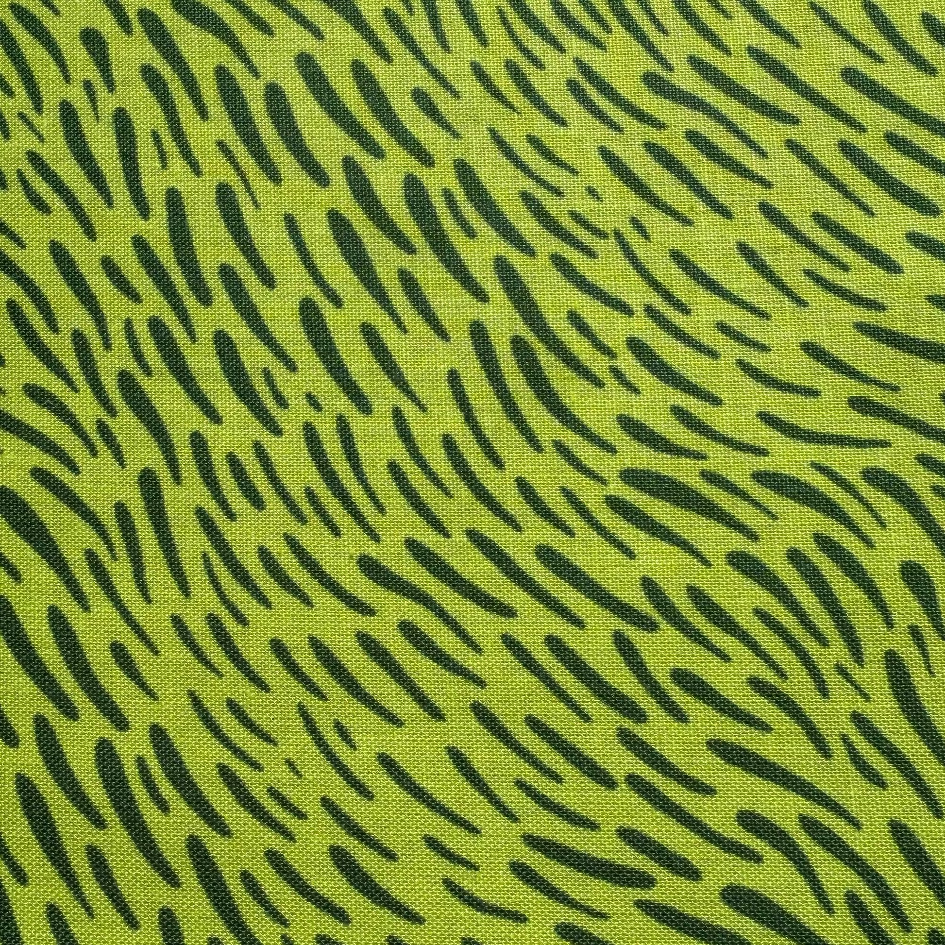 A close-up of a fabric pattern featuring a bright lime green background with a black abstract dash-like print.