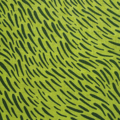 A close-up of a fabric pattern featuring a bright lime green background with a black abstract dash-like print.