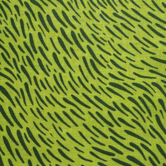 A close-up of a fabric pattern featuring a bright lime green background with a black abstract dash-like print.