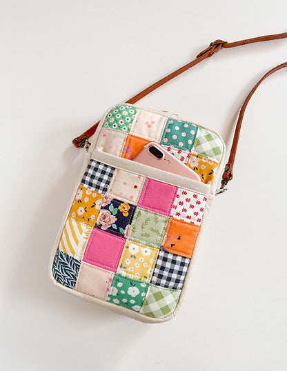 Colorful patchwork crossbody bag on a white background