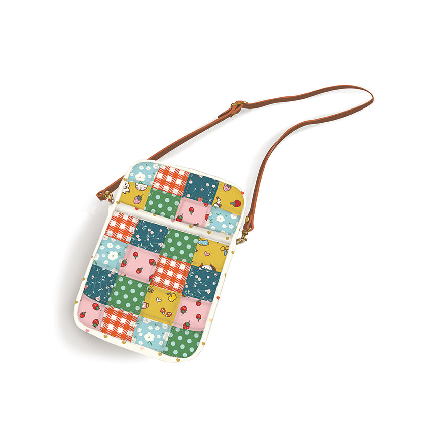 Colorful patchwork crossbody bag with a brown strap on a white background